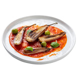 Four roasted baby eggplants sit atop a bed of smooth tomato sauce on a white TableCraft melamine serving plate, garnished with green olives and fresh basil. The vibrant colors are artfully arranged, with the white background highlighting the presentation.