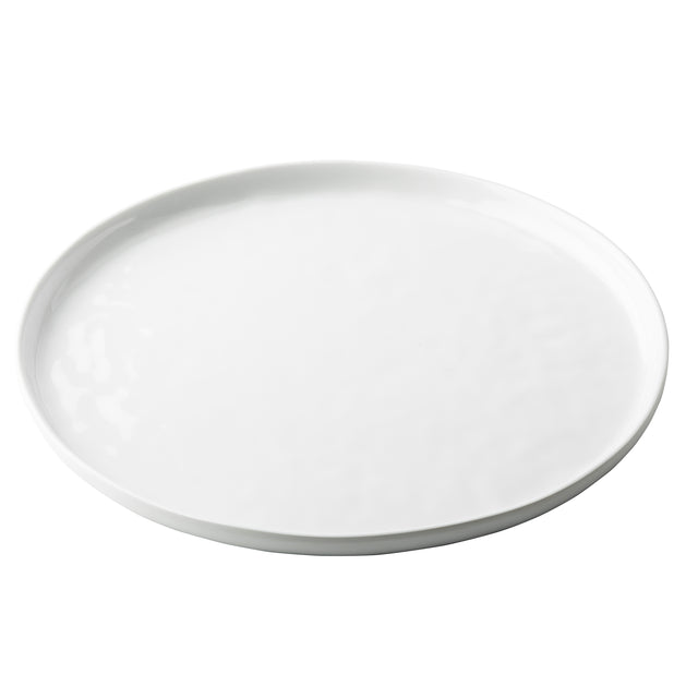 A plain, round white TableCraft Ridge Collection Serving Plate with a slightly raised edge, photographed on a white background. The plate is completely empty and features a smooth, glossy finish.