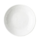 A plain, round, white TableCraft plate is shown from above against a white background. The smooth, glossy surface features subtle reflections and resembles melamine, with no visible patterns or decorations.