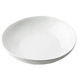 A plain, round, white serving bowl with smooth edges and a slightly glossy surface, placed on a white background. The bowl is empty and features a simple, minimalist design from the Ridge Collection.