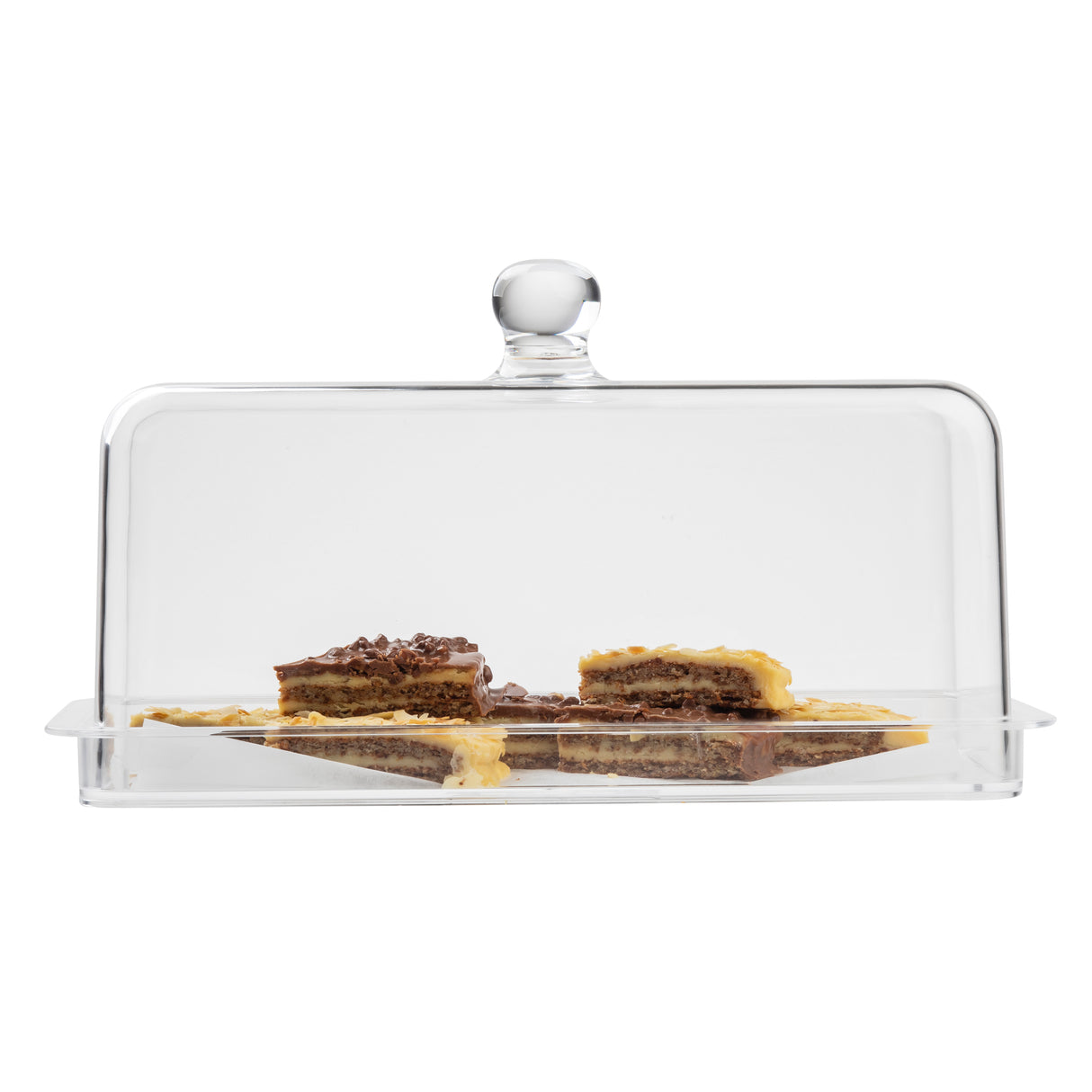A rectangular clear glass TableCraft cake dome covers several pieces of layered dessert with a brown and yellow appearance, arranged on a matching rectangular cake plate. The dome has a round handle on top, set against a plain white background.