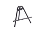 A small, black powder-coated metal tabletop easel stands on a white background. This steel card holder easel has three legs, a horizontal support bar, and features clean lines with a lightweight, minimalist frame.