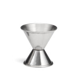 A stainless steel cocktail measuring jigger with two conical sections joined at the base, forming an hourglass shape. The top cone is larger, the bottom smaller. Used in bartending, its shiny surface reflects light beautifully.