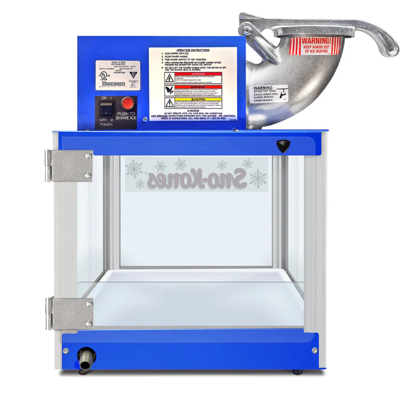 A blue and silver commercial Shav-A-Doo snow cone machine by Gold Medal Products features a large metal handle, warning labels, clear windowed sides, a switch, and “Sno-Kones” printed in reverse on the glass. The unit is displayed on a white background.