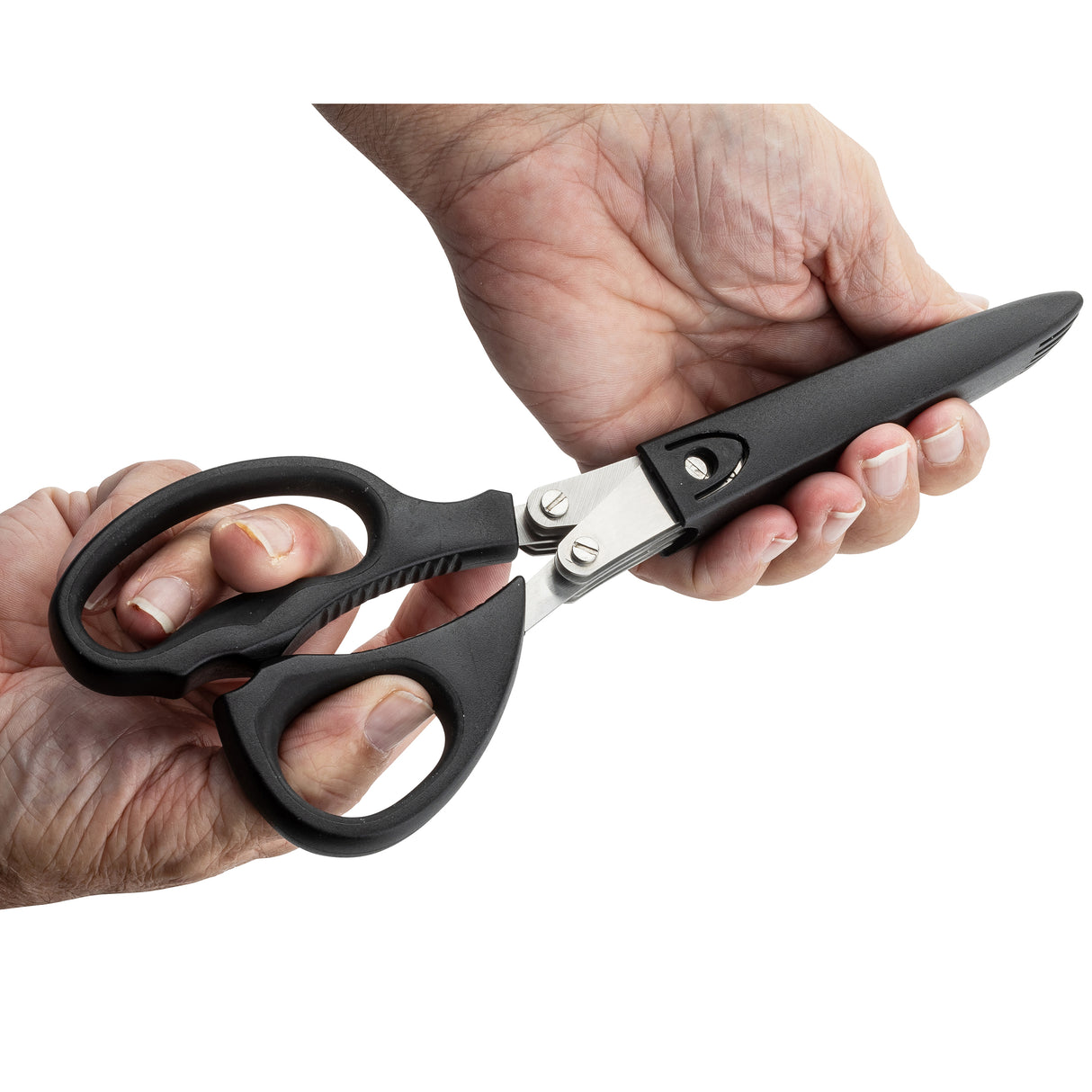 Two hands hold a pair of large black-handled herb scissors with a closed stainless steel blade. The right hand grips the PerfectGrip handle, while the left holds the blades. The plain white background draws focus to the scissors and hands.