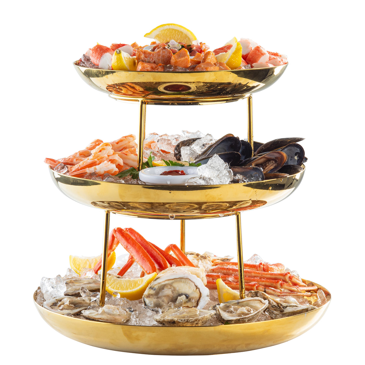 A three-tiered Seafood Tower with a gold finish holds oysters, crab legs, shrimp, mussels, and clams on ice, garnished with lemon wedges. Each tier brims with fresh shellfish for an elegant and impressive display.
