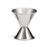 The TableCraft stainless steel jigger features a sleek, double-sided design with smooth, reflective surfaces—perfect for precise cocktail measuring. Its conical shape offers both large and small measurements against a white background.