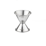 The TableCraft stainless steel jigger features a sleek, hourglass shape with one side labeled 37½ ML and the other 22½ ML, perfect for precise liquid measuring. This double-sided jigger is isolated on a white background.