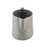 A matte gray stainless steel Frothing Cup with a pronounced pouring spout and squared handle attached by two rivets, shown against a white background. The pitcher features a modern, minimalist design.