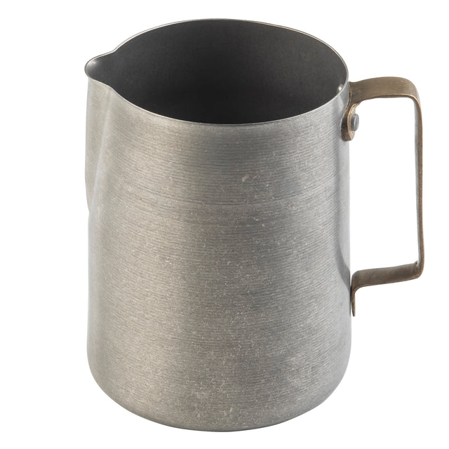 A plain stainless steel frothing cup with a narrow spout and a sturdy, angular handle attached on one side. The pitcher has a brushed, slightly worn surface and sits on a white background.