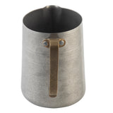 A stainless steel frothing cup with a matte, brushed finish and a wide opening. It features a sturdy, flat metal handle attached with two rivets near the top and a slightly indented spout for easy pouring. The background is white.