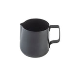 A matte black stainless steel frothing cup with a handle and small pouring spout, photographed against a plain white background. The pitcher has a simple, modern design with a wide opening.