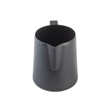 A matte black stainless steel frothing cup with a handle, viewed from above. The pitcher features a nonstick PTFE coating, a narrow spout for precise pouring, and a sleek, minimalist design set against a white background.