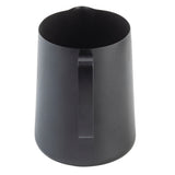 A matte black stainless steel frothing cup with a straight handle is shown against a white background. The pitcher has a simple, cylindrical shape with smooth sides and a small pouring spout at the top edge.