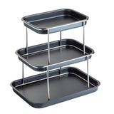 A 3-tier rectangular black metal Sharing Tower with stainless steel supports. Each tray is flat with raised edges, stacked vertically and evenly spaced, suitable for organizing, serving, or display. The background is plain white.
