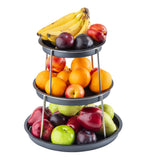 The 3-tier Sharing Tower stainless steel fruit stand holds bananas, plums, and nectarines on top; oranges, nectarines, plums, and apples in the middle; and apples, pears, plums, and a green apple on the bottom against a white background.