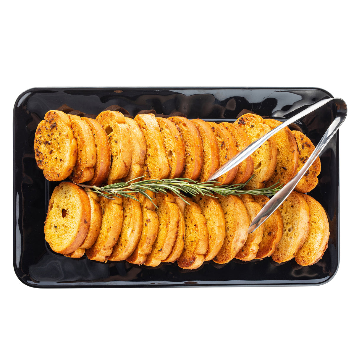 Sliced toasted baguette rounds arranged in neat rows on a black TableCraft Serving Platter made of durable melamine, garnished with a sprig of rosemary and accompanied by metal tongs, seen from overhead against a white background.