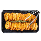 Sliced toasted baguette rounds arranged in neat rows on a black TableCraft Serving Platter made of durable melamine, garnished with a sprig of rosemary and accompanied by metal tongs, seen from overhead against a white background.