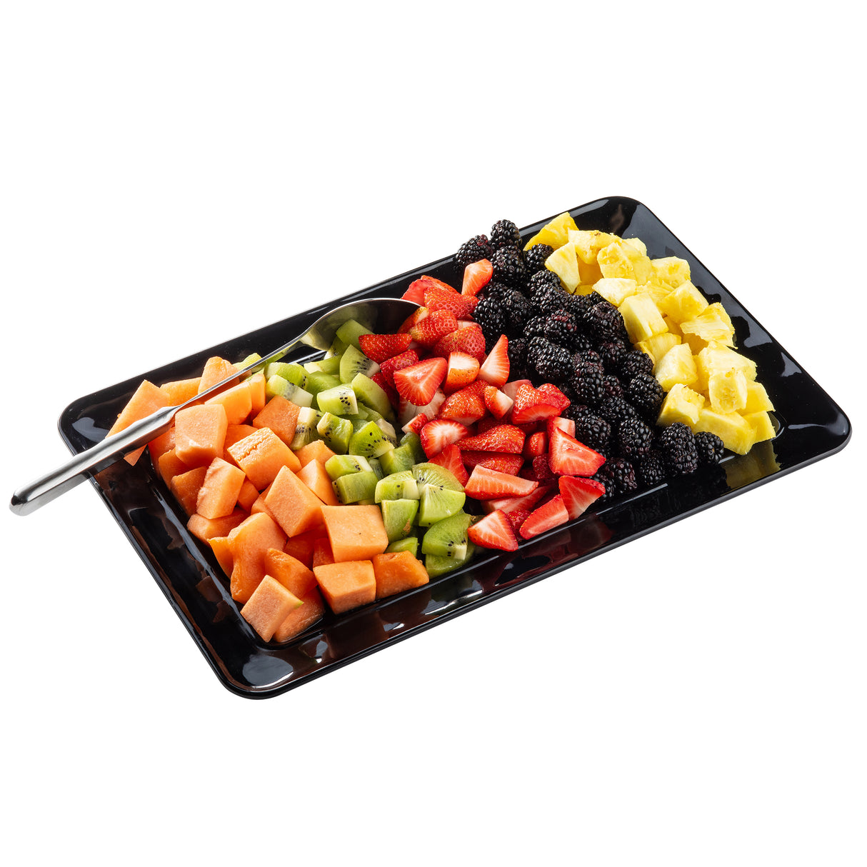 A rectangular black TableCraft platter holds neatly arranged rows of fresh fruit: cantaloupe cubes, kiwi slices, halved strawberries, blackberries, and pineapple chunks. A serving tong rests on the tray, set against a white background.