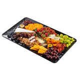 A rectangular melamine platter filled with assorted cheeses, salami, crackers, pecans, cashews, grapes, dried apricots, strawberries, blueberries, and honey containers—each arranged in neat, colorful sections on a white background.