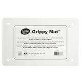 A white rectangular Grippy Mat Cutting Board by TableCraft, this anti-slip cutting mat features printed instructions in English, French, and Spanish, four reinforced corner holes, and measures 16 x 10" (40.5 x 25.5 cm).