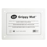 A rectangular white Grippy Mat Cutting Board by TableCraft. This anti-slip cutting mat features rounded corners, four corner holes, and a multilingual label with use and care instructions. Size: 18x13 in (45.5x33 cm).