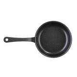 A black non-stick fry pan with a smooth surface and a long handle featuring a hole at the end. This Mini Serving Fry Pan by TableCraft Products is empty and photographed from above on a white background.