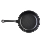 A black Mini Serving Fry Pan by TableCraft with a non-stick coating and a long handle featuring a hole at the end, viewed from above on a white background. The smooth interior surface appears clean, with no food or utensils present.