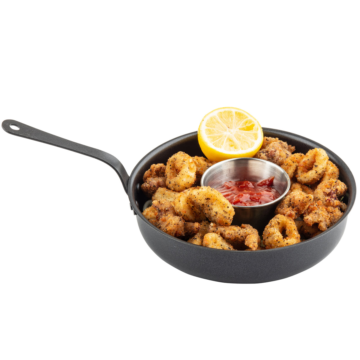 A TableCraft Products mini serving fry pan holds crispy, golden brown breaded calamari rings, garnished with a half lemon. A small metal cup of red dipping sauce sits in the center, ready for dipping.