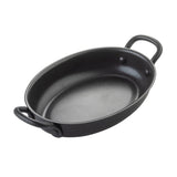 A black, oval-shaped non-stick fry pan from TableCraft Products with two sturdy handles, photographed on a white background. The smooth, deep interior is ideal for baking or roasting small portions, making it perfect as a Mini Serving Fry Pan.