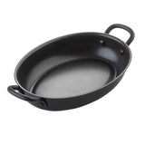 A black, oval-shaped TableCraft Mini Serving Fry Pan with two curved riveted handles and a smooth non-stick coating, perfect for baking, roasting, or serving food. Shown on a white background for a sleek presentation.