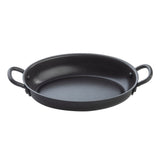 A black, oval-shaped TableCraft roasting pan with a non-stick coating and two sturdy handles sits on a plain white background. The smooth, shallow interior makes it ideal for baking or roasting, while the outward-curved handles offer easy gripping.