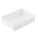 A plain, rectangular white ceramic dish with smooth sides and slightly rounded corners, viewed at an angle from above against a white background. This clean, minimalist half size bowl is ideal for serving and fits seamlessly with TableCraft Products.