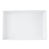 A large, empty rectangular white ceramic tray with raised edges is shown from a top-down perspective on a plain white background, offering the same clean lines and glossy finish found in TableCraft and Simple Solutions Bowl collections.