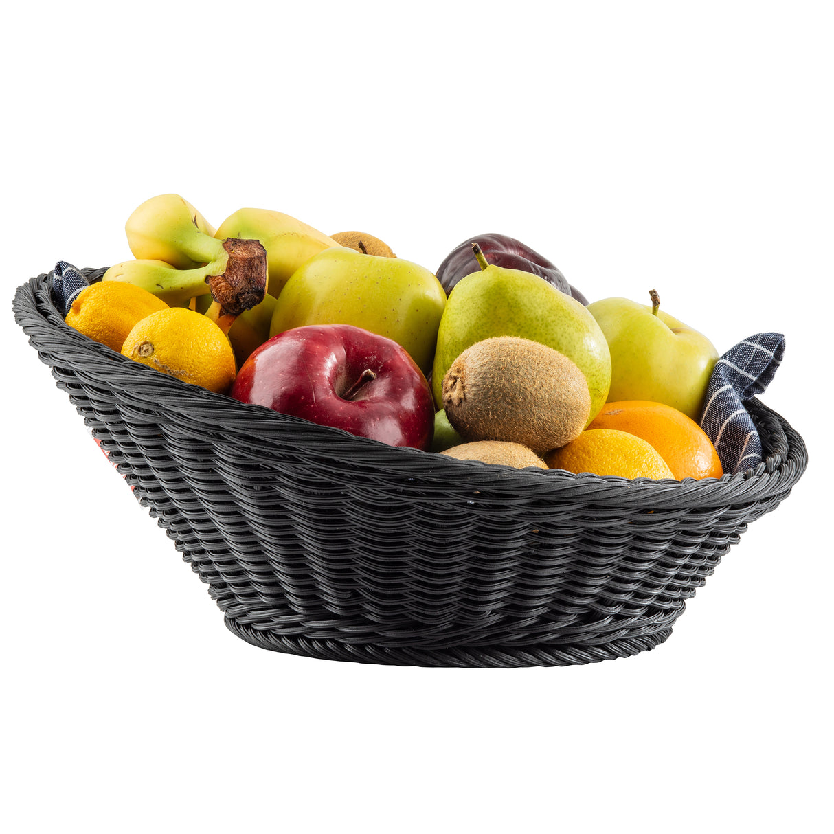 A TableCraft 12129 handwoven basket filled with assorted fruits—bananas, apples, kiwis, oranges, and lemons—rests atop a blue checkered cloth, all set against a white background.
