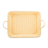 A rectangular, light-colored handwoven basket with rounded corners and two looped handles on opposite sides, viewed from above against a white background. The basket appears empty and has a tightly woven texture.