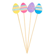 Four wooden Decorative Picks, each topped with a colorful Easter egg—yellow, pink, purple, and blue. Each egg features white stripes and dotted patterns, fanned out neatly on a white background. Perfect for festive TableCraft Products displays.