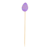 A TableCraft Products bamboo pick topped with a flat, purple egg-shaped decoration featuring colorful horizontal stripes and dots, resembling an Easter egg. The background is plain white. A festive choice from the Decorative Picks collection.