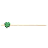 A wooden TableCraft bamboo pick with a pointed tip and a small green shamrock decoration attached near one end, placed on a white background.