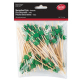 A clear plastic bag contains 100 bamboo picks, each topped with a green shamrock shape. The package label reads Decorative Picks – Shamrock and includes the TableCraft logo. The picks are 4.5 inches (11.5 cm) long.