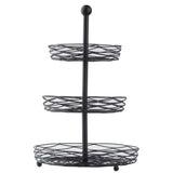 A black powder coated steel, three-tier display basket from the Artisan Collection features circular baskets of increasing size, supported by a central rod with a round knob. The open design ensures easy visibility and access to stored items.
