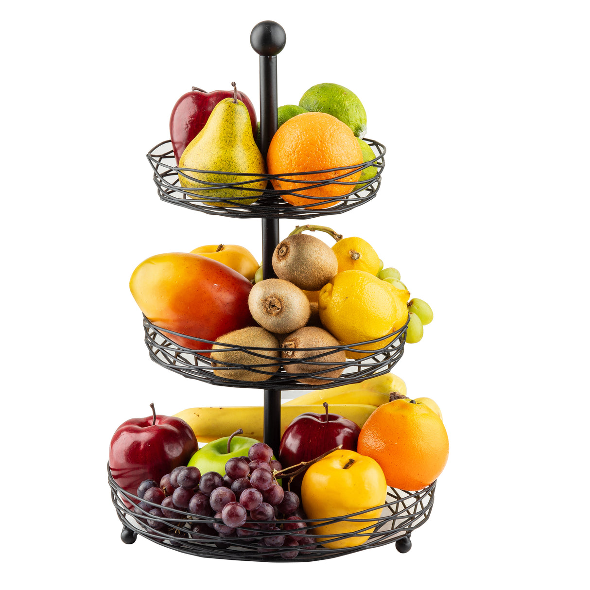 A three-tiered Artisan Collection Display Basket, crafted from black powder coated steel, holds assorted fruits—apples, pear, lime, mango, kiwi, bananas, lemons, grapes, and an orange—beautifully arranged against a white background.