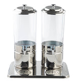 A 4 gallon beverage dispenser set with two clear polycarbonate cylindrical containers and silver lids, spigots, and bases. Both sit on a rectangular metal tray with two round drip grates in front of the spigots. The dispensers are empty.