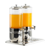 Two tall, cylindrical 4-gallon beverage dispensers stand side by side on a matching metal tray, filled with orange juice. Each dispenser features a spigot for pouring and a lid with a knob. The background is plain white.