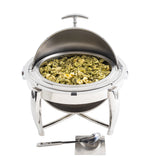A round stainless steel chafer with a dripless roll top lid displays cooked tortellini pasta. The 6 qt. chafer stands on a stylish metal tripod base, and a serving spoon rests on a small rectangular plate in front of it. The background is white.