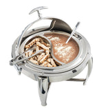 A round stainless steel chafer with a partially open lid features grilled chicken strips on one side and creamy brown soup topped with grated cheese on the other. Metal tongs and a ladle rest in their sections, enhancing this elegant dripless roll top chafer setup.