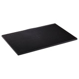A rectangular black rubber service mat with a textured, raised dot pattern covers the surface. The mat has a slight border around the edges, is dishwasher safe, and rests on a white background.
