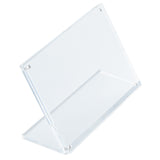 A clear Acrylic Sign Holder is shown angled slightly to the right on a white background. The holder stands upright with a slanted design, featuring two transparent panels joined at the base to display paper or signage from TableCraft Products.