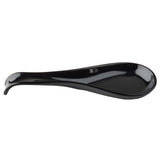 A glossy black Spoon Rest by TableCraft with a curved, elongated shape and a shallow central depression to hold utensils. The smooth, reflective surface and raised back edge prevent slipping, making it a sleek addition to your kitchen.