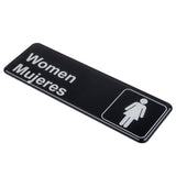 A rectangular black polystyrene women sign with white text that reads Women Mujeres and an icon of a woman in a dress, set inside a white-bordered square on the right side of this cash and carry sign.